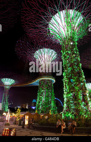 Singapore, Singapore - December 9, 2014: Visitors gather around the Supertree Grove at Gardens by the Bay in Singapore. The nigh Stock Photo
