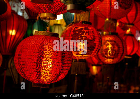 Focus on a Chinese lantern with the words 'Blessings' printed on it among an array of red lanterns in the background. Stock Photo