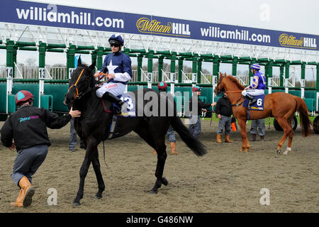 Horse Racing - William Hill Rosebery Stakes Day - Kempton Park. Jockey Denis Sweeney on Gaily Noble (left) goes towards the starting gates for the williamhill.com Rosebery Handicap Stock Photo