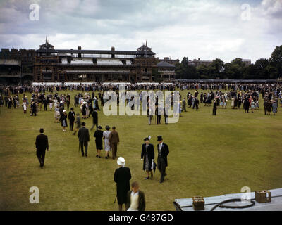 Spectators at the Eton v Harrow match enjoy a walk on the outfield during the lunch interval Stock Photo