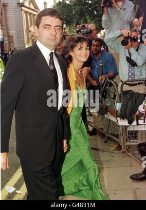 Comedian Rowan Atkinson and his wife, Sunitra, arrive for the premiere of 'Bean - The Ultimate Disaster Movie', in Chelsea, west London. The comedy film stars Atkinson, who has become Britain's highest paid actor earning 11.25million in 1997 - ahead of Lord Attenborough and Sir Anthony Hopkins - it was disclosed on 18/1/98. See PA Story SHOWBIZ Actors. Photo by Stefan Rousseau/PA. Stock Photo