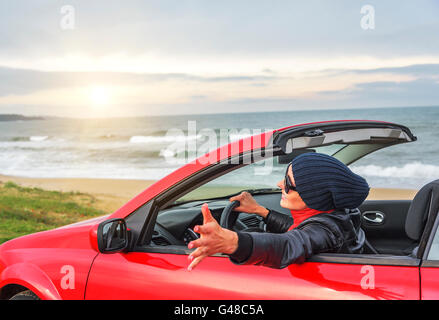 Relaxing woman on the beach in the car. Vacationor trip concept. Stock Photo