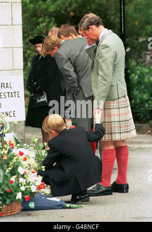 Prince Harry holds onto his father's hand when they stopped outside the gates to Balmoral Castle to look at the floral tributes today (Thursday). Stock Photo