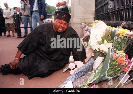 A man cries as he lays flowers outside Buckingham Palace today (Sunday) following the news of Diana, Princess of Wales' death in the early hours of this morning after her car crashed at high speed in Paris late last night. Her friend, Dodi Fayed and the driver of the car were also killed. Stock Photo