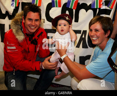 Private Jaco Van Gass is greeted by his niece Amelia Van Dermerwe (7 months) and his sister Lizanne Van Dermerwe as he arrives at Gatwick Airport with the other members of the Walking with The Wounded Team after their successful trip to the North Pole. Stock Photo