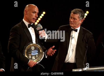 Referee Howard Webb (left), winner of the special merit award with Sky Sports Presenter George Gavin during the 2011 PFA Player of the Year Awards at the Grosvenor House Hotel, London. Stock Photo