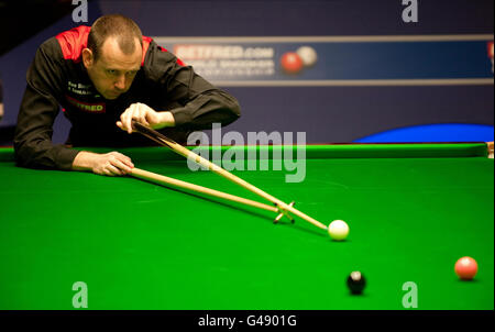 Mark Williams in action against Mark Allen during their quarter final match of the Betfred.com World Snooker Championships at the Crucible, Sheffield. Stock Photo