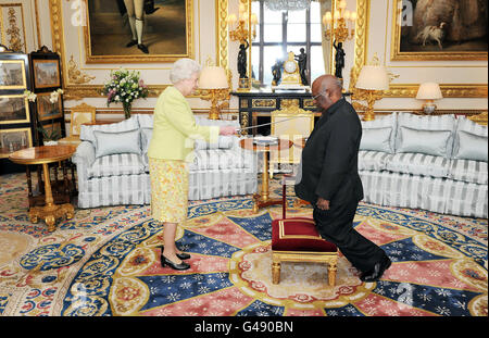 Queen Elizabeth II grants the Governor-General of Papua New Guinea, Michael Ogio, the Grand Cross of the Order of St Michael and St George in the White Room at Windsor Castle. Stock Photo