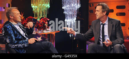 (left to right) Presenter Graham Norton with guest, Hugh Laurie, during filming of The Graham Norton Show, at The London Studios, south London, to be aired on BBC One on Friday evening. Stock Photo