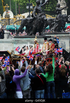 Prince William and his bride Kate make their way to Buckingham Palace, London in the royal procession after the wedding ceremony. Stock Photo