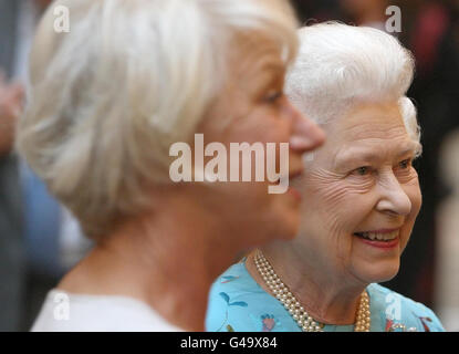 Queen Elizabeth II meets Dame Helen Mirren at a reception to celebrate young people in the performing arts, at Buckingham Palace, in central London. Stock Photo