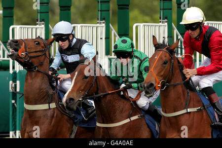 Dijarvo ridden by Luke Morris, Choisirez ridden by Jim Crowley and Best Terms ridden by Richard Hughes break out the stall for the Scope Charity Fillies' Conditions Stakes during the Scope Charity Race Day at Newbury Raceourse. Stock Photo