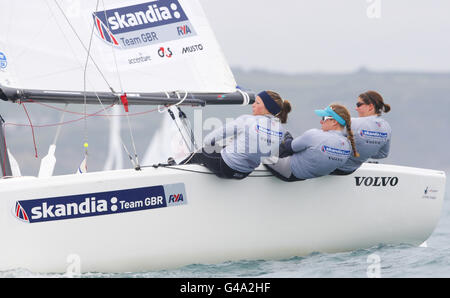 British Olympic sailing team members in the Match Racing event (left to right) Kate Macgregor, Annie Lush and Lucy Macgregor at the Weymouth and Portland National Sailing Academy, the sailing venue for the London 2012 Olympic Games. Stock Photo