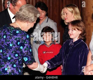 Britain's Queen Elizabeth II, shakes hands with 11-year-old Melissa Smith, from Bormley in Kent. Melissa, a patient of Great Ormond Street Hospital, since birth, was at the front of the procession of mourners, connected with the many charities Diana was involved with, who followed the coffin to Westminster Abbey. The Queen met the youngsters after attending a concert dedicated to the memory of Diana, Princess of Wales, in aid of the Royal Academy of Music and the Great Ormond Street Children's Hospital at the Royal Festival Hall in London this evening (Wednesday) to. See PA Story ROYAL Stock Photo