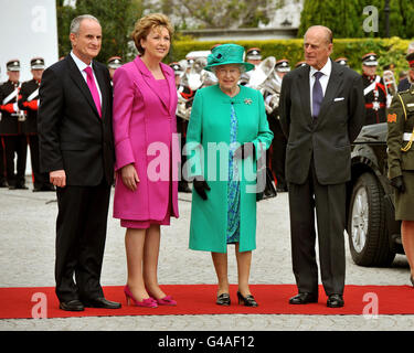 Queen Elizabeth II (second right) with Irish President Mary McAleese (second left) after arriving at Aras an Uachtarain (The Irish President's official residence) in Phoenix Park, Dublin, Ireland, as Dr Martin McAleese (far left) and The Duke of Edinburgh (far right) look on. Stock Photo
