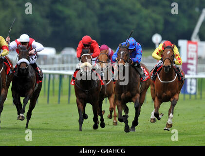 Horse Racing - Betfred Silver Bowl and Temple Stakes - Haydock Park. Overdose (red) ridden by jockey Andreas Suborics disappoints by finishing well down the field during the betfred.com Temple Stakes Stock Photo