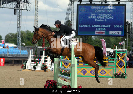 Mark Armstrong riding Thesaura competes in a jumping competition during day three of the Royal Windsor Horse Show at The Royal Mews, Windsor Castle, London. Stock Photo