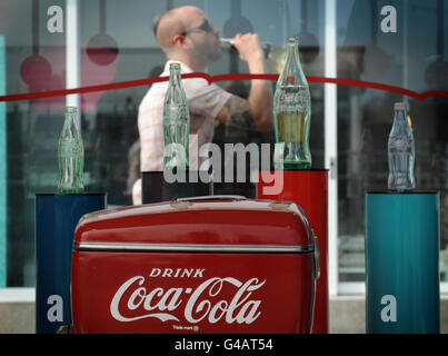 To help mark the 125th anniversary of Coca-Cola the Design Museum in London have put an exhibition in their Tank, outside the main building in Shad Thames including Coca-Cola's famour contour bottle and examples of their logo. It depicts the history of the famous drink and it's design icons. Stock Photo