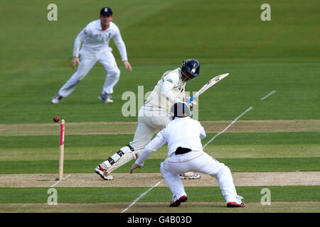 Cricket - npower First Test - Day One - England v Sri Lanka - SWALEC Stadium. Sri Lanka's Tharanga Paranavitana pushes the ball past England's Ian Bell during day one npower First Test at the SWALEC Stadium, Cardiff. Stock Photo