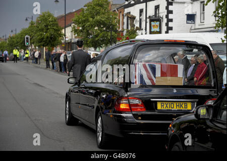 A hearse carrying the coffin of Colour Serjeant Kevin Fortuna, of A Company, 1st Battalion The Rifles, makes it's way through Wootton Bassett, after the soldier's body was repatriated at RAF Lyneham following his death in Afghanistan on Monday. Stock Photo