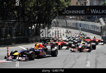 Germany's Sebastian Vettel of Red Bull leads into the first corner followed by Great Britain's Jenson Button in his Vodafone McLaren Mercedes during the Monaco Grand Prix at the Circuit de Monaco, Monte Carlo. Stock Photo