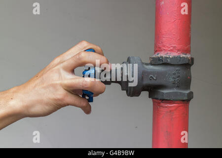 Closeup hands opening Industrial hand valve Stock Photo