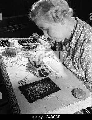 Ruby Essan working on the crown for the Coronation robe at the Royal School of Needlework, Kensington. It will be incorporated into the robe above the royal cypher. Stock Photo