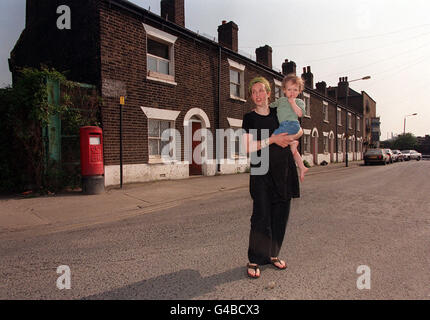 Six and a half months pregnant single mother Carolyne Rushton with her 22-month-old daughter Bertha. became a sitting tenant in the middle of the New Millennium Dome Experience at Greenwich after a successful plea to the Court of Appeal today (Monday). Carolyne is fighting attempts to evict her from the 19th Century gas worker's cottage, at River Way (background) which is next to the dome development in south east London, where she has lived for more than 13 years. See PA Story COURTS Dome. Photo by Fiona Hanson/PA. Stock Photo