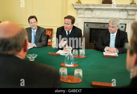 Prime Minister David Cameron (centre) with Deputy PM Nick Clegg (left) and Health Secretary Andrew Lansley in the Cabinet Room, where they met with Steve Field (left, back to camera) to discuss the NHS Future Forum report, in 10 Downing Street, this morning. Stock Photo