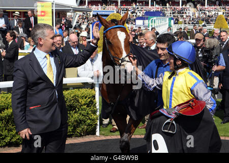 Winning jockey Eddie Ahern (right) with trainer Donald McCain (left) in the winners enclosure after victory on Overturn in the totesport.com Chester Cup Stock Photo