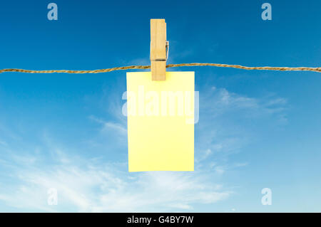 paper notes hanging on rope and sky background Stock Photo