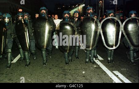 A line of French policemen wearing full riot gear march through the streets of Marseille last night (Sunday June 14) after trouble broke out amongst rival soccer fans gathered in the port's bars ahead of England's opening World Cup match against Tunisia in the city later today. The police responded with tear gas as fans reapeatedly challenged them, throwing bottles and chairs. See PA story SPORT Cup Riots. Photo by Peter Jordan/PA Stock Photo