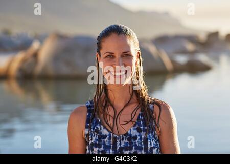MODEL RELEASED. Young woman with wet hair smiling towards camera, portrait. Stock Photo