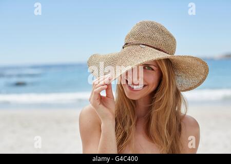 MODEL RELEASED. Young woman wearing a sunhat, portrait. Stock Photo