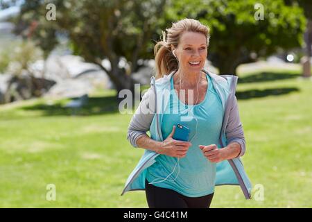 MODEL RELEASED. Senior woman exercising listening to music. Stock Photo