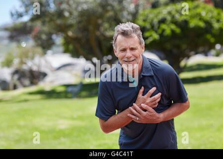 MODEL RELEASED. Senior man holding his chest in pain. Stock Photo
