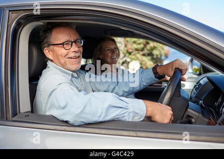 MODEL RELEASED. Senior man in car, smiling. Stock Photo