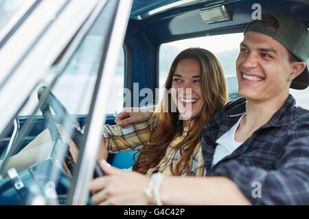 MODEL RELEASED. Young couple in a car, laughing. Stock Photo