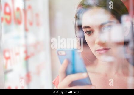 MODEL RELEASED. Young woman using smartphone. Stock Photo