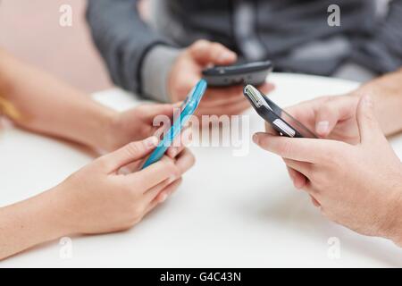 MODEL RELEASED. People using smartphones at the same time. Stock Photo