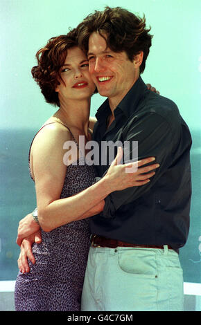 Hugh Grant cuddles up to co-star Jeanne Tripplehorn on the roof of the ...