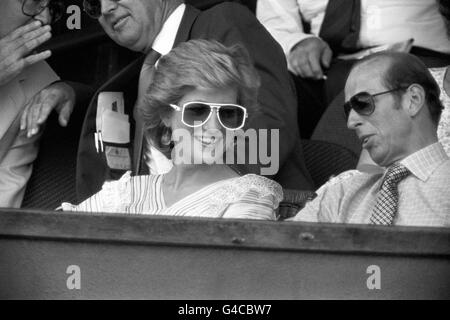 Diana Princess of Wales, sporting white rimmed sunglasses and dropped sphere earrings, watches the action from the Royal Box on Centre Court at Wimbledon with The Duke of Kent. Stock Photo
