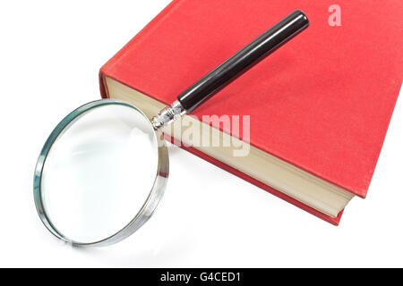 Antique magnifying glass on red book Stock Photo