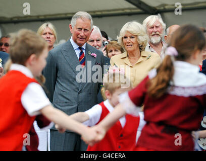 The Prince of Wales and the Duchess of Cornwall watch a display of traditional Welsh folk dancing by children from Ysgol Rhys Prichard primary school at Llandovery railway station which the Duchess and the Prince of Wales officially opened following it's refurbishment. Stock Photo