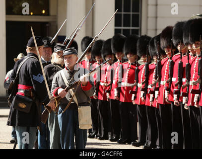 Members of The Southern Skirmish Association (SoSkAn) American Civil War Re-enactment Society with soldiers from the Grenadier Guards, during the launch of The British Military Tournament at Wellington Barracks in central London. Stock Photo