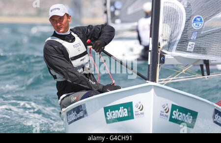 Giles Scott, who is competing with triple Olympic gold medalist Ben Ainslie for a place at London 2012, in action in his Finn dinghy during day three of the Skandia Sail for Gold Regatta in Dorset. Stock Photo