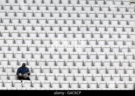 Cricket - Liverpool Victoria County Championship - Division One - Day One - Nottinghamshire v Worcesteshire - Trent Bridge. A lone fan in the stands reads the local newspaper during the County Championship match between Nottinghamshire and Worcesteshire Stock Photo