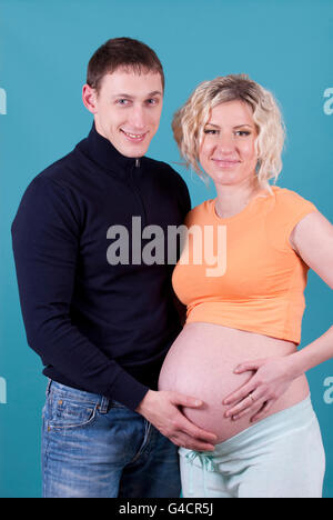 Pregnant woman and young man together indoors Stock Photo - Alamy