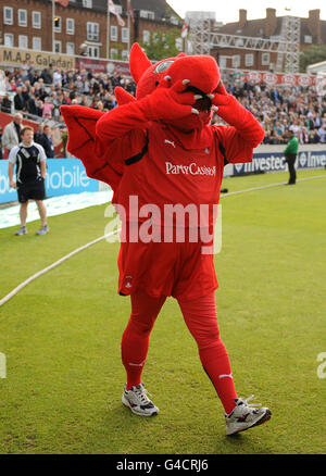 Leyton Orient mascot Theo the Wyvern waves to the crowd as the North London team take to the field for the mascot derby Stock Photo