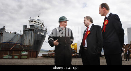 Former Deputy Prime Minister John Prescott (centre) with candidate Iain McKenzie (right), talk with a staff member (no name given) at Ferguson Ship Builders in Port Glasgow, on the final day of campaigning ahead of the Inverclyde by-election. Stock Photo